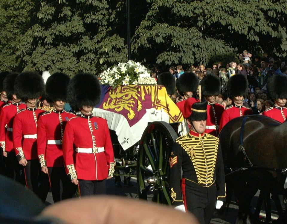 FILE - The gun carriage bearing the coffin of the Princess Diana, draped in the Royal Standard, leaves London's Kensington Palace on route for the funeral service at London's, Westminster Abbey, on Sept. 6 1997. Princess Diana was killed in a car crash in Paris on Aug. 31, 1997. A new documentary film "The Princess," premiers on Aug. 13 on HBO Max. (AP Photo/Ben Curtis, Pool, File)