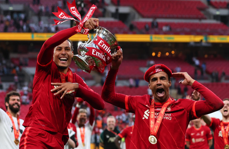 LONDON, ENGLAND - MAY 14: Virgil van Dijk and Joel Matip of Liverpool celebrate with the Emirates FA Cup trophy following their team's victory in The FA Cup Final match between Chelsea and Liverpool at Wembley Stadium on May 14, 2022 in London, England. (Photo by Marc Atkins/Getty Images)