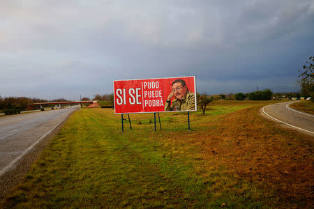 A view of a billboard that reads in Spanish, "Yes we could. yes we can, yes we will be able to", near the town of Pedro Pi in Cuba, April 3, 2018. REUTERS/Alexandre Meneghini