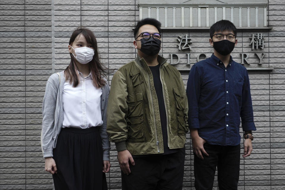 Hong Kong activists, from right, Joshua Wong, Ivan Lam and Agnes Chow arrive at a court in Hong Kong, Monday, Nov. 22. 2020. The trio appear at court for their trial as they face charges related to the besieging of a police station during anti-government protests last year. (AP Photo/Vincent Yu)