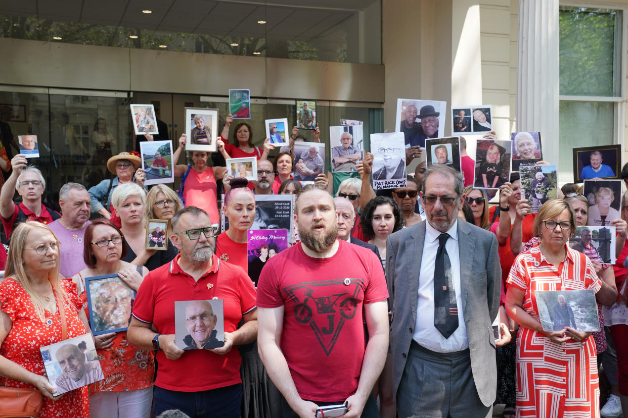 People hold pictures of loved ones lost during the pandemic outside Dorland House in London where the inquiry is hearing evidence for its first investigation (Module 1) examining if the pandemic was properly planned for and 