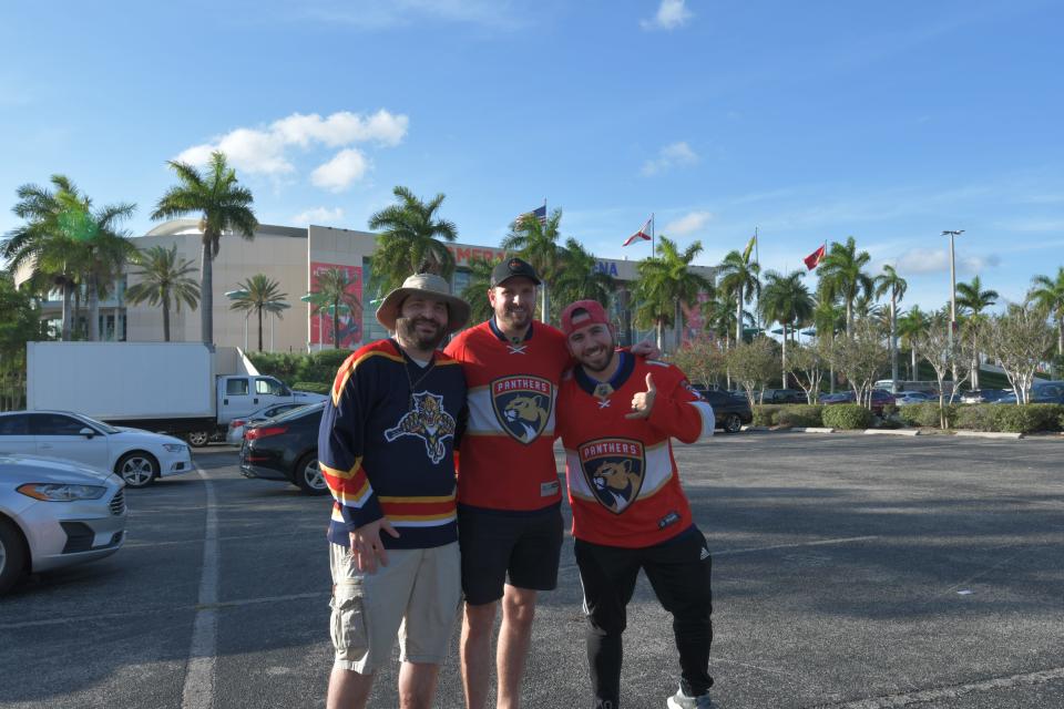 Panthers fans Christopher Cormio, Jeff Perez, and Manuel Suarez pose while tail-gating outside Amerant Bank Arena ahead of the Panthers' watch party for Game 6 (June 21, 2024).