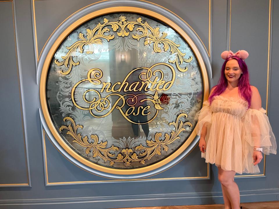 jenna posing with the sign for enchanted rose at the grand floridian resort