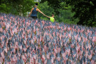 <p>Visitors walk past a field of United States flags displayed by the Massachusetts Military Heroes Fund on the Boston Common in Boston on May 26, 2016, ahead of the Memorial Day holiday on May 30. The 37,000 U.S. flags are planted in memory of every fallen Massachusetts service member from the Revolutionary War to the present. (Brian Snyder/Reuters) </p>