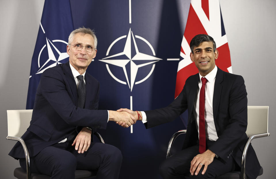 NATO Secretary General Jens Stoltenberg, left, and Britain's Prime Minister Rishi Sunak shake hands prior to talks at the Warsaw Armoured Brigade in Warsaw, Poland, Tuesday April 23, 2024. (Henry Nicholls/Pool via AP)