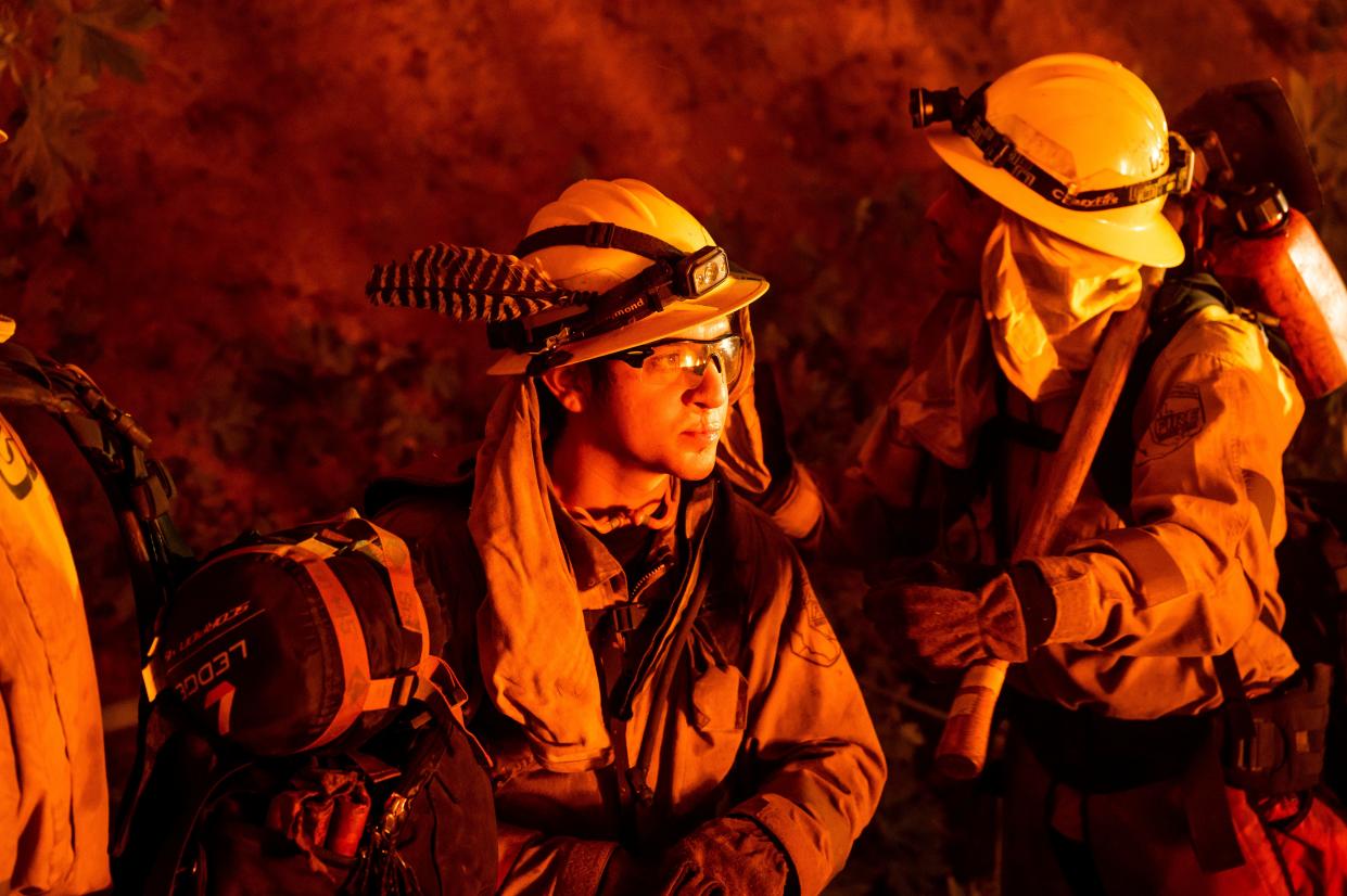 Firefighters prepare to battle the Mosquito Fire burning on Michigan Bluff Road in unincorporated Placer County, Calif., on Wednesday, Sept. 7, 2022.