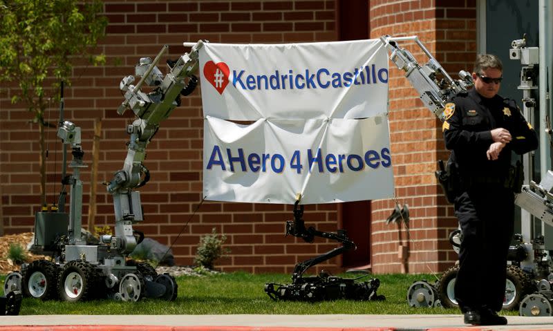 FILE PHOTO: Police department robots hold up a banner outside the memorial service of the shooting victim Kendrick Castillo of the Science, Technology, Engineering and Math (STEM) School in Highlands Ranch