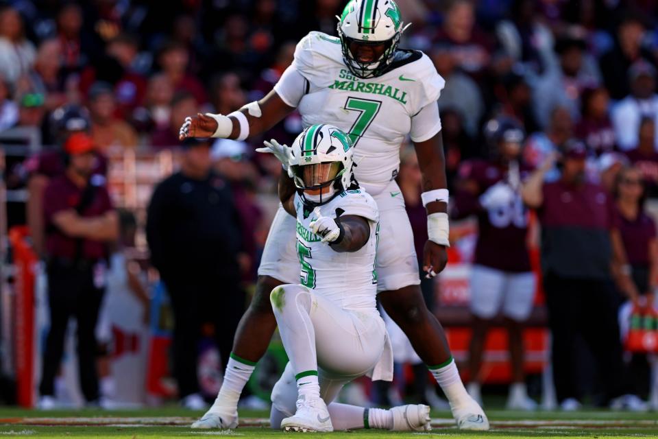 Marshall defensive lineman Mike Green celebrates after sacking Virginia Tech quarterback Kyron Drones.