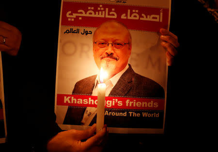 A demonstrator holds a poster with a picture of Saudi journalist Jamal Khashoggi outside the Saudi Arabia consulate in Istanbul, Turkey October 25, 2018. REUTERS/Osman Orsal/Files