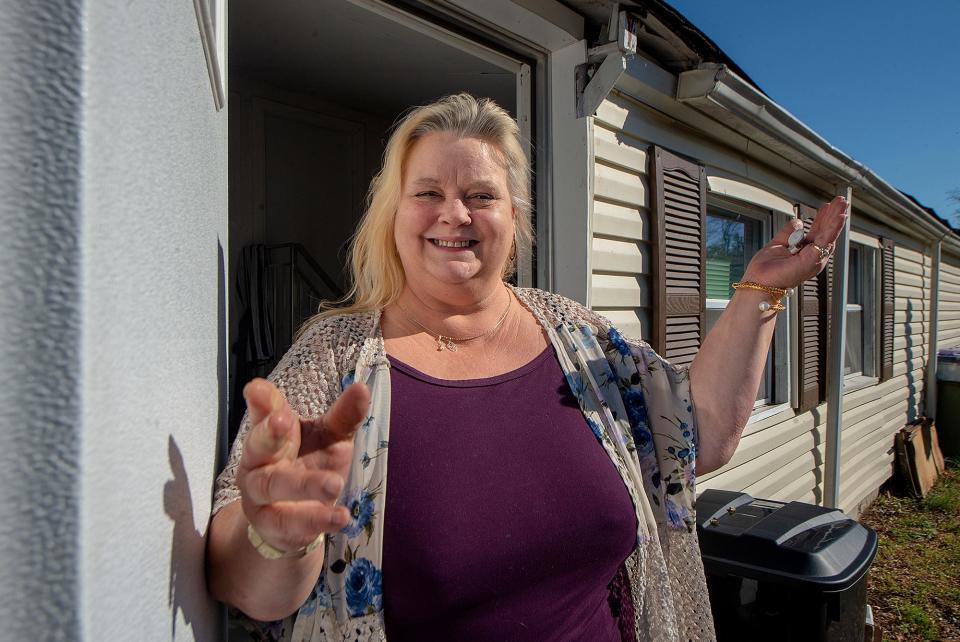 Karen McDonald is all smiles with her mobile home in Falls Township, on Monday, Nov. 8, 2021.