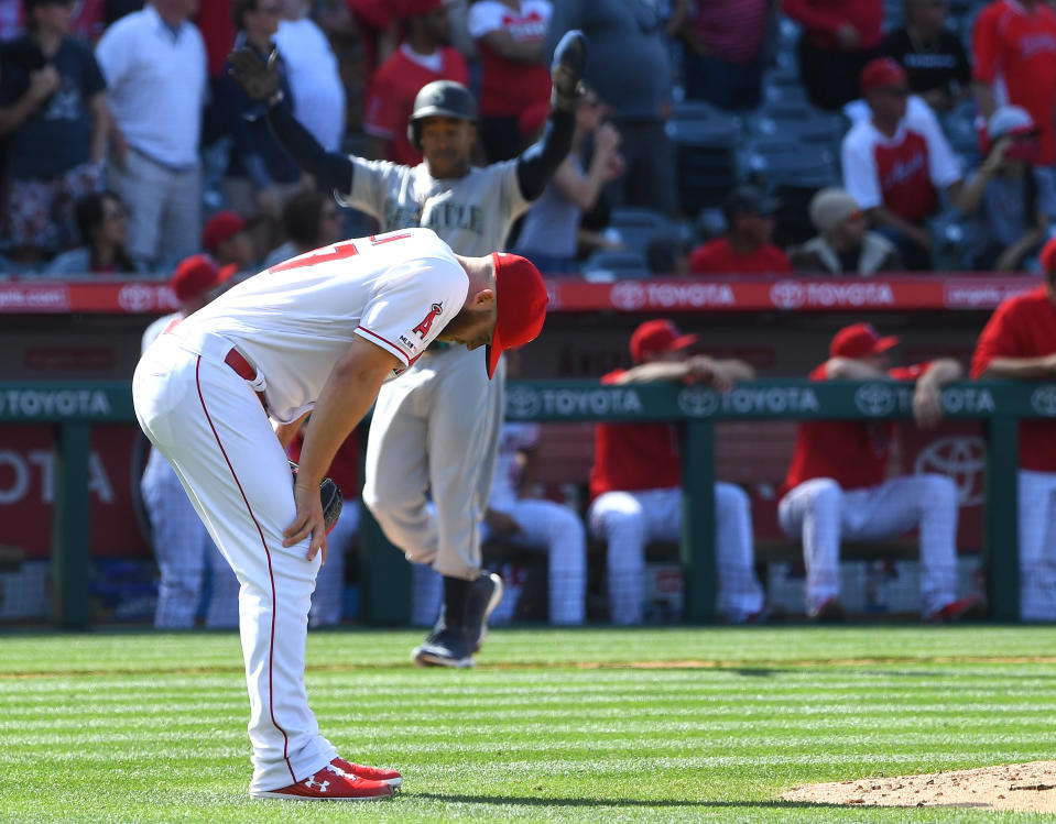 ANAHEIM, CA - APRIL 21: Mallex Smith #0 of the Seattle Mariners celebrates at third bas as relief pitcher Cody Allen #37 of the Los Angeles Angels of Anaheim hangs his head after giving up a two run home run to Mitch Haniger #17 of the Seattle Mariners in the ninth inning of the game at Angel Stadium of Anaheim on April 21, 2019 in Anaheim, California. (Photo by Jayne Kamin-Oncea/Getty Images)