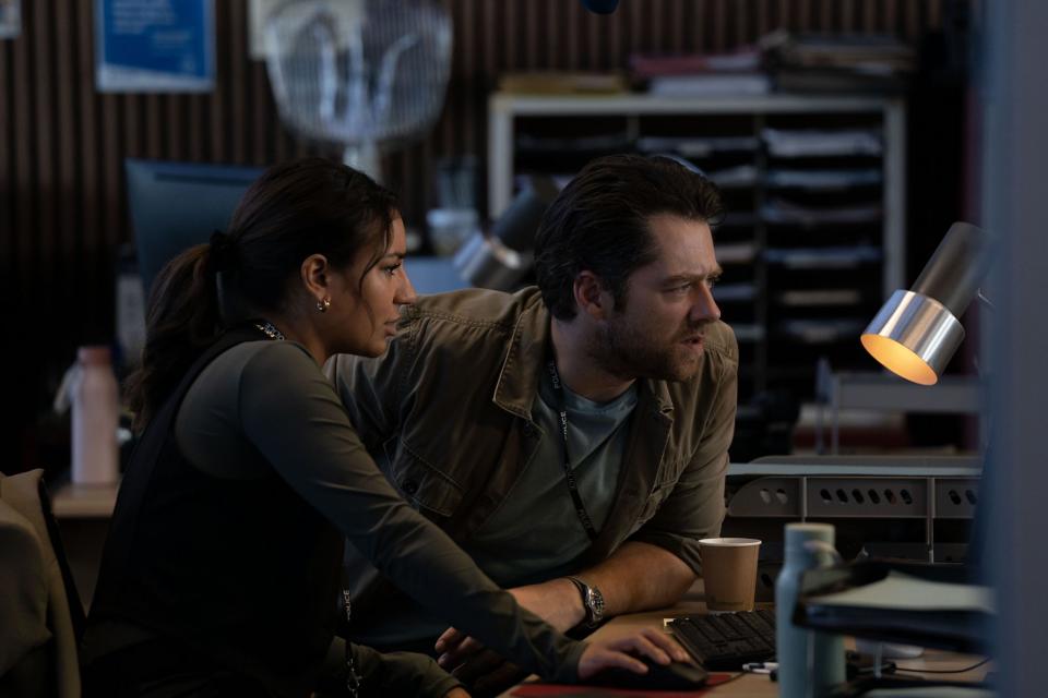 Lucie Shorthouse as Siobhan Clarke and Richard Rankin as John Rebus, hunched over a computer