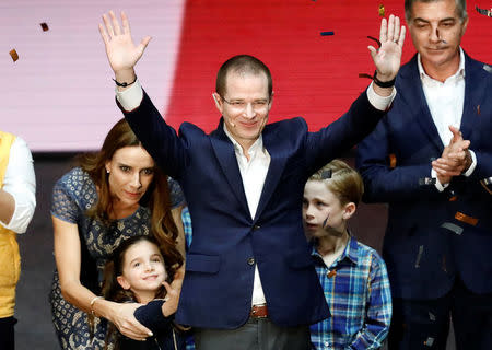 Ricardo Anaya, accompanied by his wife Carolina Martinez and his children, gestures after being sworn-in as presidential candidate of the National Action Party (PAN), who leads a left-right coalition, at the Auditorio Nacional in Mexico City, Mexico February 18, 2018. REUTERS/Edgard Garrido