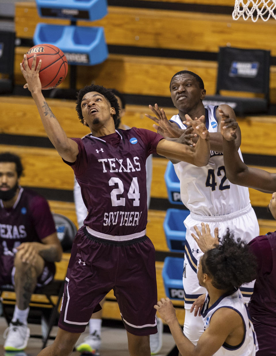 Texas Southern forward John Walker III (24) grabs a rebound next to Mount St. Mary's forward Malik Jefferson (42) during the second half of a First Four game in the NCAA men's college basketball tournament Thursday, March 18, 2021, in Bloomington, Ind. (AP Photo/Doug McSchooler)