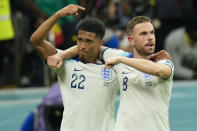 England's Jordan Henderson, right, celebrates scoring the opening goal with teammate Jude Bellingham during the World Cup round of 16 soccer match between England and Senegal, at the Al Bayt Stadium in Al Khor, Qatar, Sunday, Dec. 4, 2022. (AP Photo/Francisco Seco)