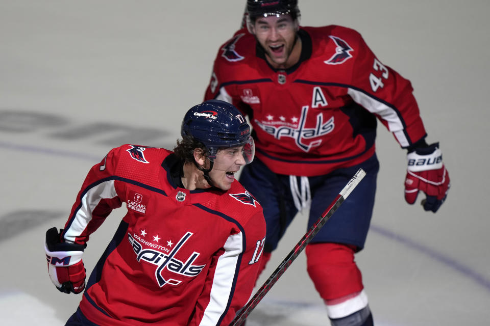 Washington Capitals center Dylan Strome, front, celebrates with right wing Tom Wilson after scoring against the Buffalo Sabres in overtime of an NHL hockey game Wednesday, Nov. 22, 2023, in Washington. (AP Photo/Mark Schiefelbein)