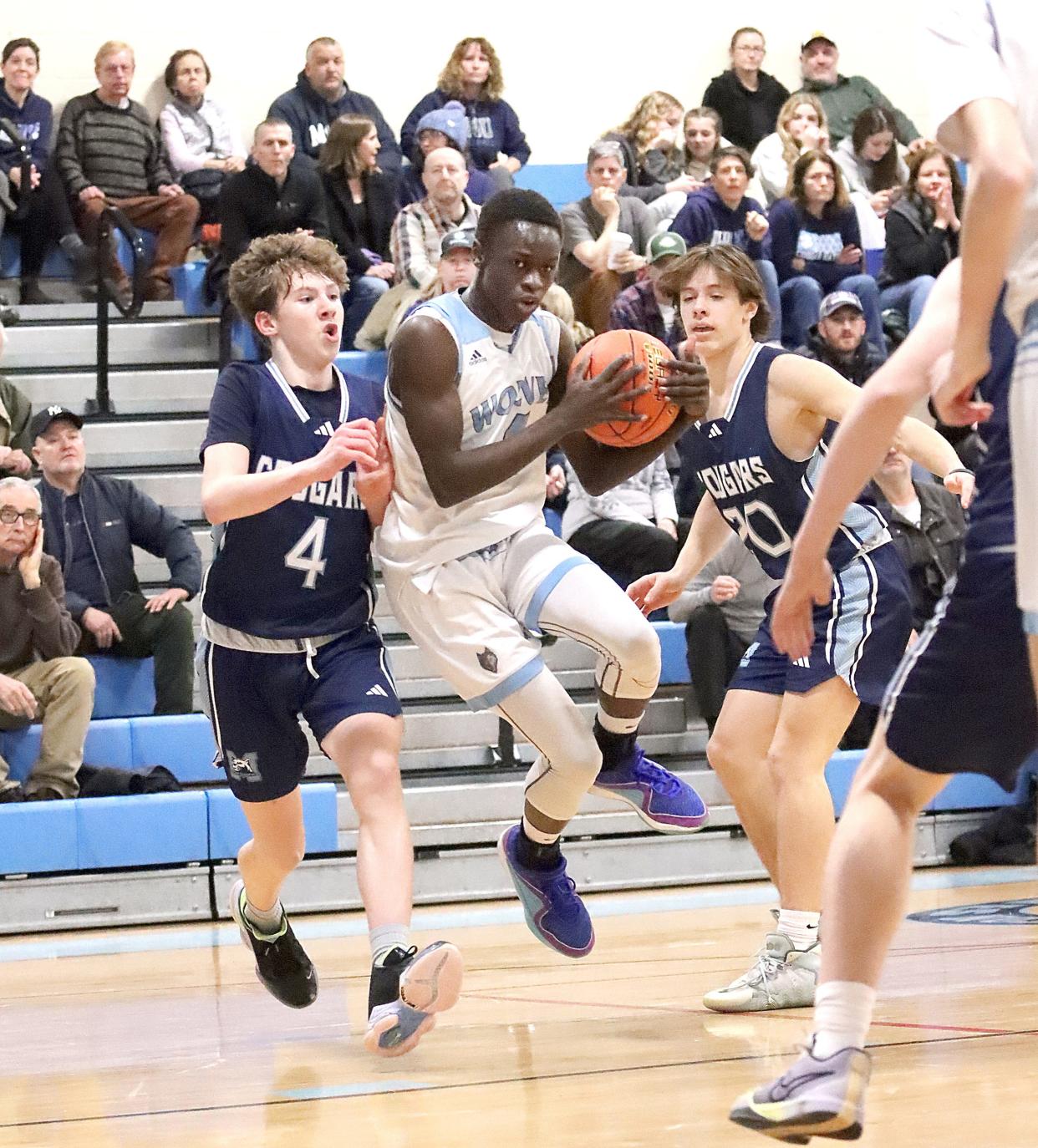 South Burlington's Deng Aguek jumps into the lane during the Wolves 57-50 loss to MMU in the 2024 D1 playdowns.