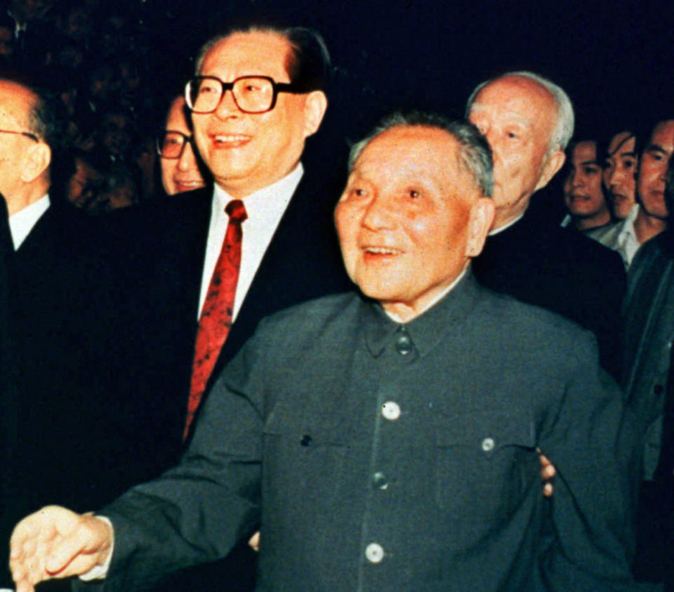 FILE - In this photo provided by China's Xinhua News Agency, then Chinese leader Deng Xiaoping, center, meets delegates of the Communist Party Central Committee in Beijing on Oct. 19, 1992. Then Communist Party General Secretary Jiang Zemin is seen at left. With his death, former Chinese leader Jiang leaves behind a very different China than the one he tried to shape. Now it’s Xi Jinping’s nation. (Xinhua News Agency via AP)