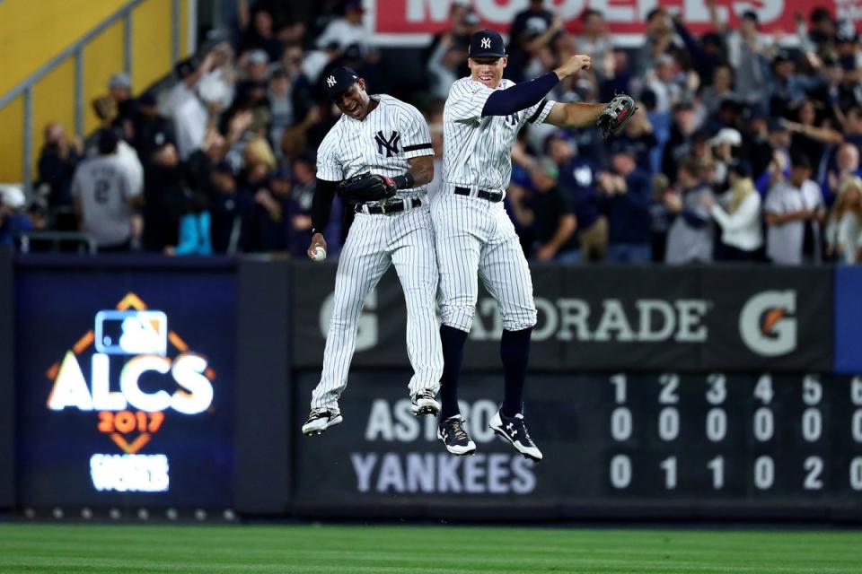 Aaron Hicks and Aaron Judge of the New York Yankees celebrate after beating the Houston Astros in Game 5 of the ALCS on Oc. 18, 2017 (Getty)