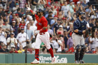 Boston Red Sox's Jonathan Arauz, left, points toward the stands as he crosses home past Tampa Bay Rays catcher Francisco Mejia after his home run during the seventh inning of a baseball game Monday, Sept. 6, 2021, at Fenway Park in Boston. (AP Photo/Winslow Townson)