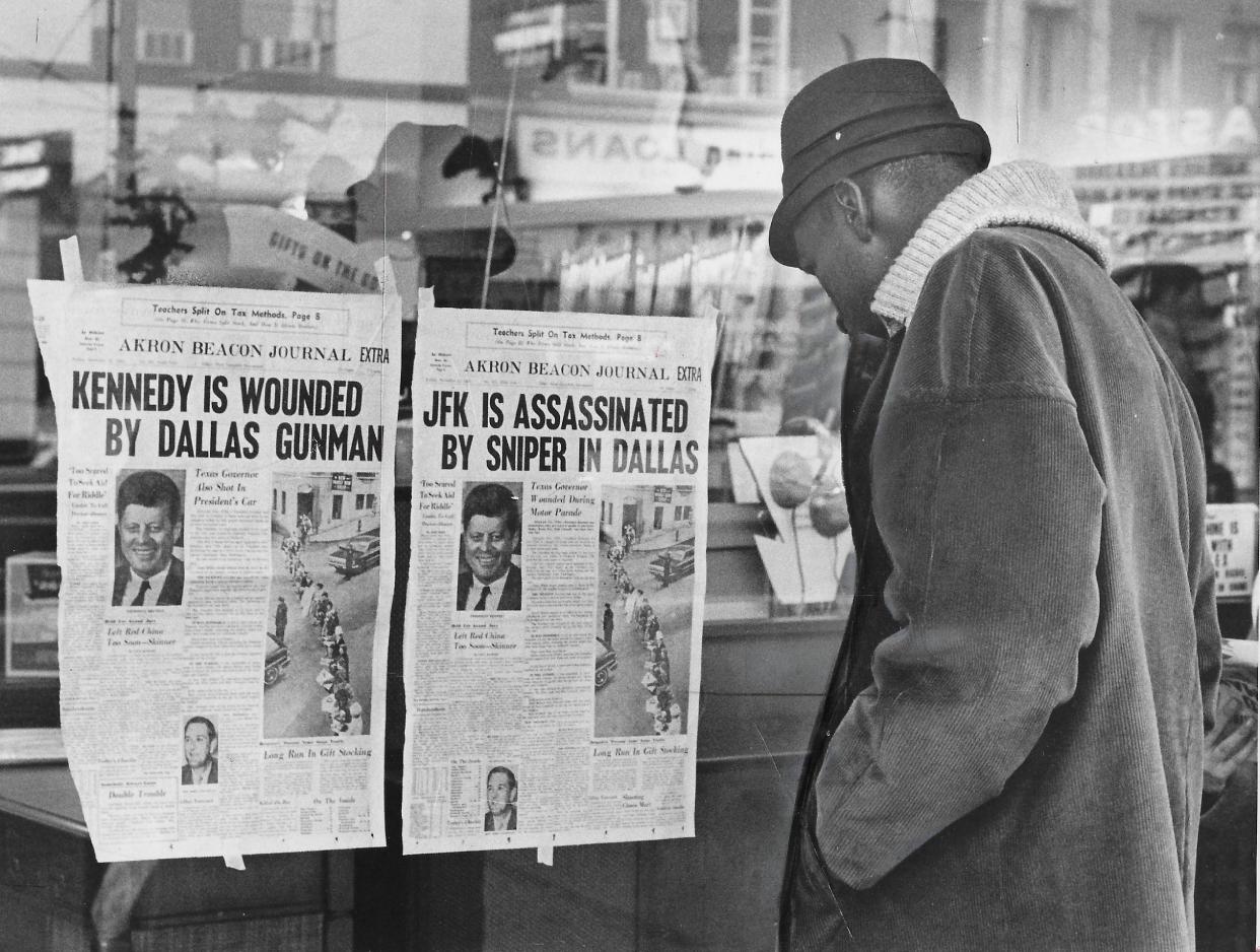 A pedestrian stops to read the front pages taped to a store window on South Main Street in downtown Akron on Nov. 22, 1963. The banner headline originally read “KENNEDY IS WOUNDED BY DALLAS GUNMAN” before being amended to “JFK IS ASSASSINATED BY SNIPER IN DALLAS.”