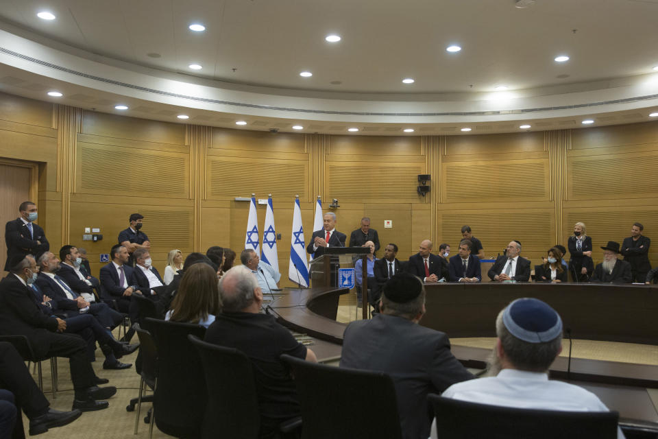 Former Israeli Prime Minister Benjamin Netanyahu speaks to right-wing opposition party members a day after a new government was sworn in, at the Knesset, Israel's parliament, in Jerusalem, Monday, June 14, 2021. (AP Photo/Maya Alleruzzo)