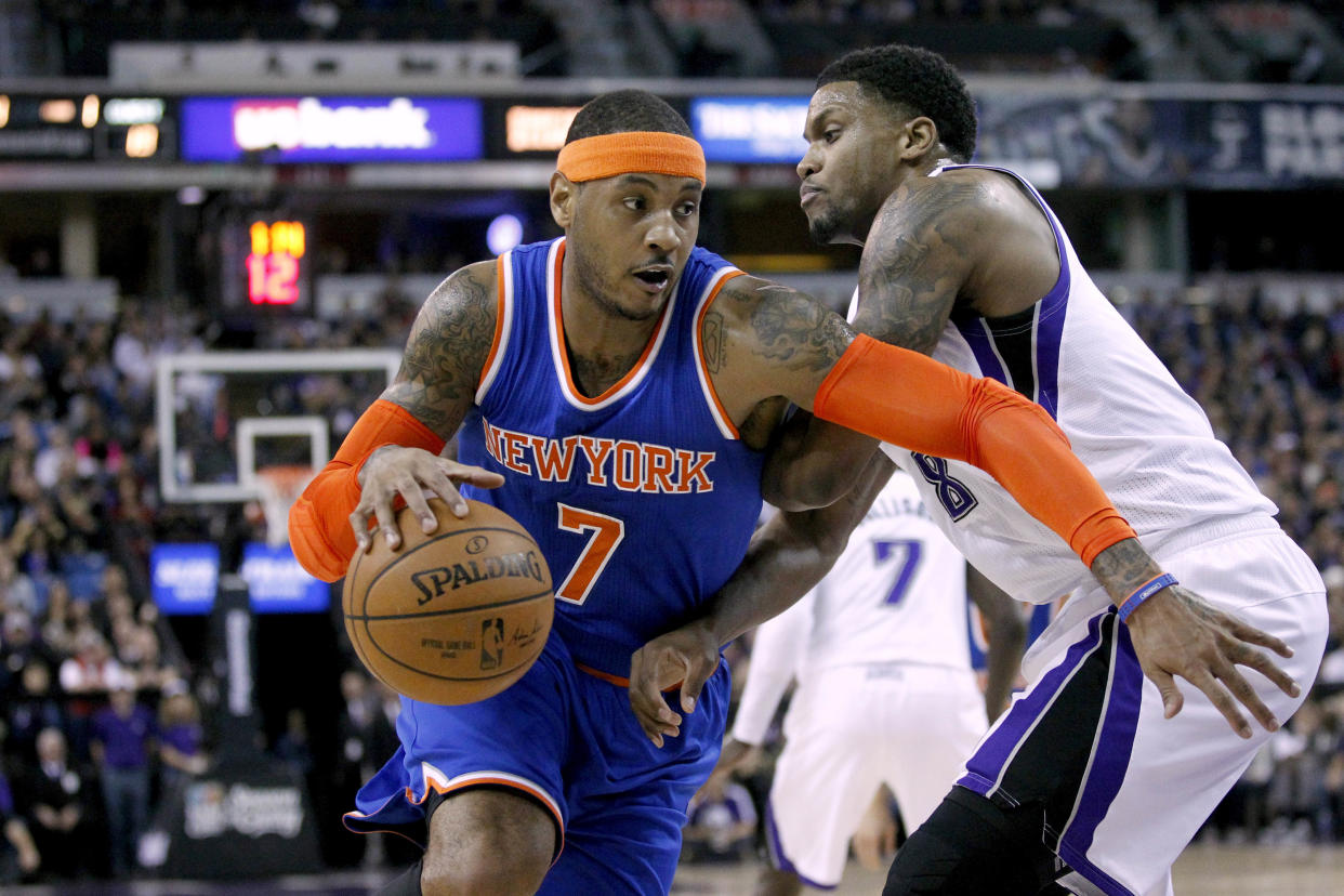 Dec 27, 2014; Sacramento, CA, USA; New York Knicks forward Carmelo Anthony (7) dribbles the ball around Sacramento Kings forward Rudy Gay (8) in the first quarter at Sleep Train Arena. Mandatory Credit: Cary Edmondson-USA TODAY Sports