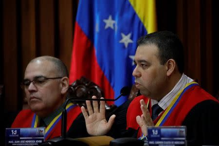 Venezuela's Supreme Court Second Vice President and President of the Constitutional Chamber Juan Mendoza (R), seated next to Arcadio Delgado, a member of the of the Constitutional Chamber, gives a news conference in Caracas, Venezuela, July 21, 2017. REUTERS/Carlos Garcia Rawlins