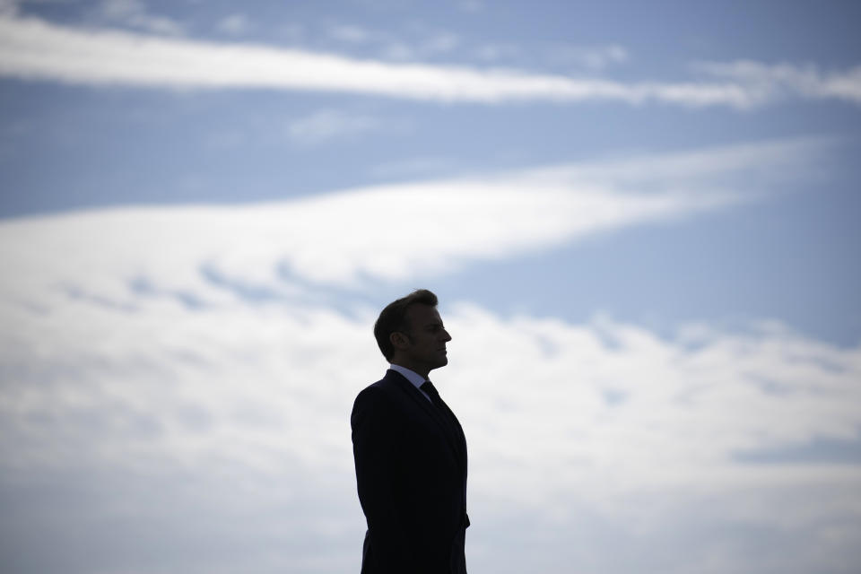 FILE - French President Emmanuel Macron attends a ceremony at the Croix du Souvenir monument, Tuesday, June 18, 2024 on the Île de Sein, Brittany. Emmanuel Macron once appeared as a bold, young leader offering to revive France through radical pro-business, pro-European policies so that voters have "no reason anymore" to vote for the extremes. Seven years after he was first elected, his call for snap elections weakens him at home and abroad, while it appears to propel the far right on the verge of power. (AP Photo/Christophe Ena, Pool, File)