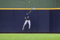Tampa Bay Rays' Randy Arozarena can't make the catch at the wall on a home run by Milwaukee Brewers' Willy Adames during the seventh inning of a baseball game Wednesday, May 1, 2024, in Milwaukee. (AP Photo/Kenny Yoo)