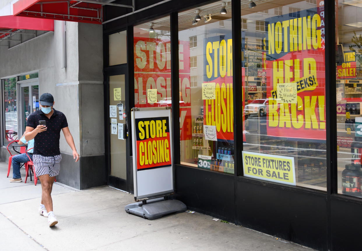 NEW YORK, NEW YORK - AUGUST 07:  A person wears a protective face mask outside the GNC store as the city continues Phase 4 of re-opening following restrictions imposed to slow the spread of coronavirus on August 7, 2020 in New York City. The fourth phase allows outdoor arts and entertainment, sporting events without fans and media production. (Photo by Noam Galai/Getty Images)