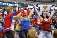 Russian team fans cheer during the men's preliminary round ice hockey game against Team USA at the 2014 Sochi Winter Olympics, February 15, 2014. REUTERS/Gary Hershorn