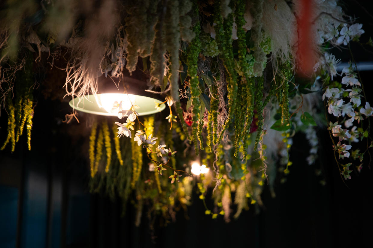 Flowers hang above a row of seats at Sidebar on Monday, April 29, 2024, in South Bend.