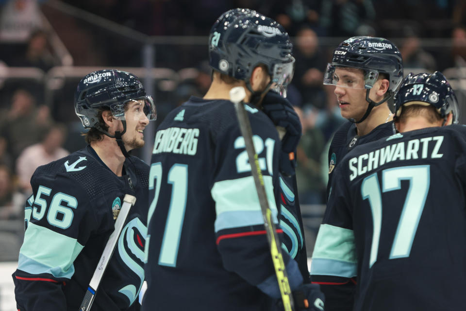 Seattle Kraken right wing Kailer Yamamoto (56) celebrates with teammates after scoring during the first period of a preseason NHL hockey game against the Edmonton Oilers, Monday, Oct. 2, 2023, in Seattle. (AP Photo/Jason Redmond)