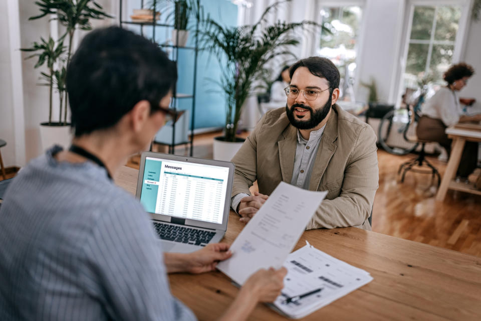 A man talks to a hiring manager during a job interview