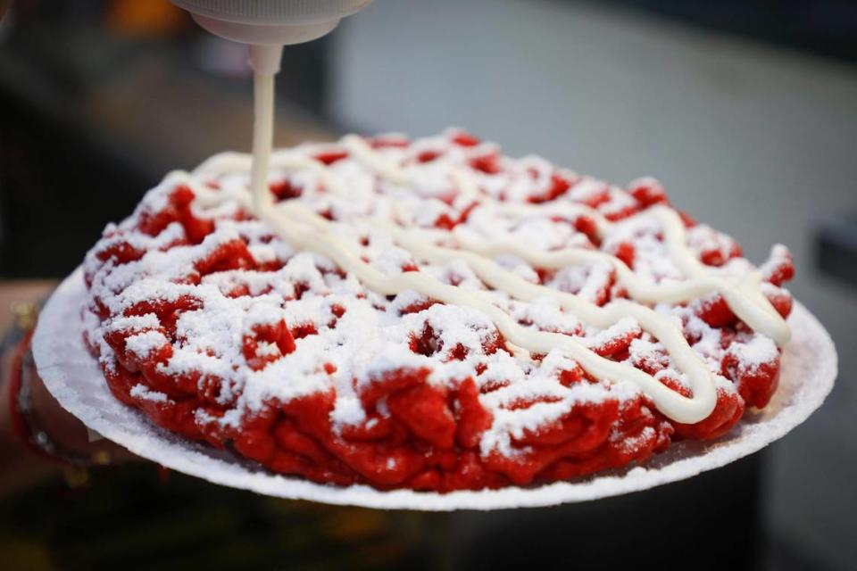 A deep-fried red velvet funnel cake topped with powered sugar and cream cheese frosting at George’s Fun Foods at the Lexington Lions Club’s Bluegrass Fair at Masterson Station Park in Lexington, Ky., Friday, June 11, 2021.