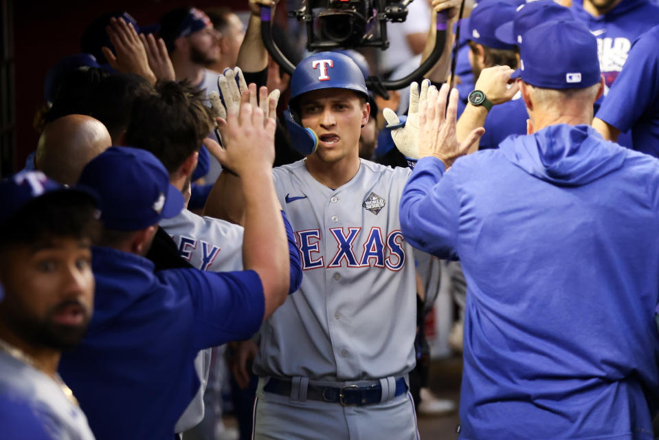 PHOENIX, AZ - OCTOBER 31:   Corey Seager #5 of the Texas Rangers celebrates with teammates in the dugout after hitting a two-run home run in the second inning during Game 4 of the 2023 World Series between the Texas Rangers and the Arizona Diamondbacks at Chase Field on Tuesday, October 31, 2023 in Phoenix, Arizona. (Photo by Rob Tringali/MLB Photos via Getty Images)