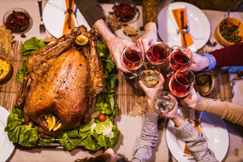 PHOTO: A group toasts with wine over a Thanksgiving table in an undated stock photo. (STOCK PHOTO/Skynesher/Getty Images)