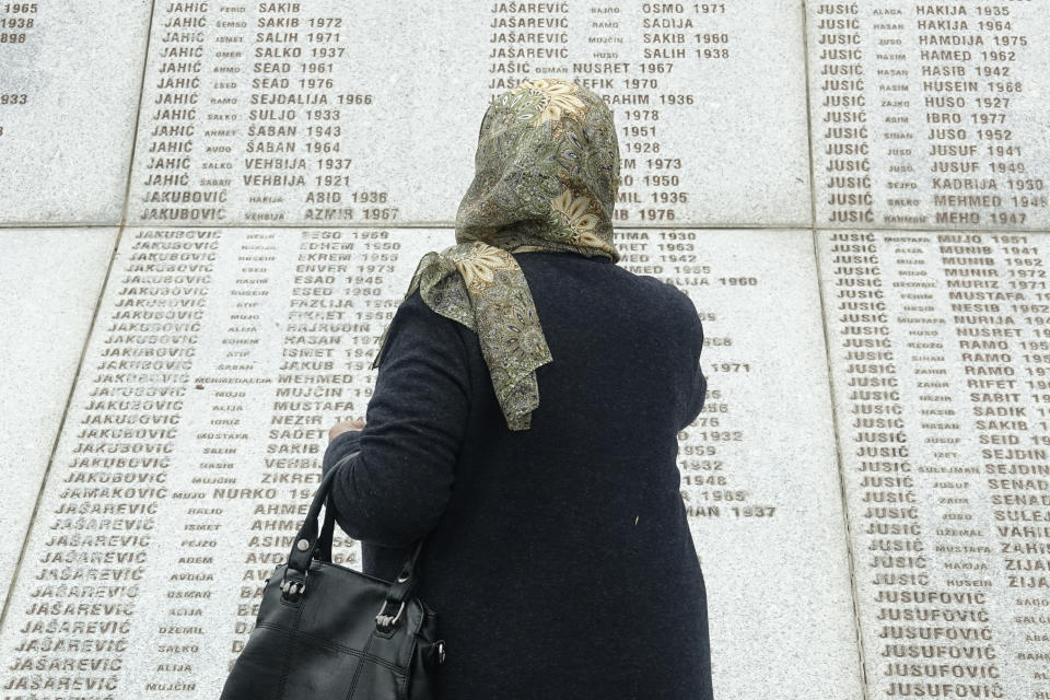 Djulija Jusic who lost her two sons and the 33 relatives in Srebrenica massacre, looks at names at the memorial cemetery in Potocari near Srebrenica, Bosnia, Friday, May 28, 2021. U.N. judges on Tuesday, June 8 deliver their final ruling on the conviction of former Bosnian Serb army chief Radko Mladic on charges of genocide, war crimes and crimes against humanity during Bosnia’s 1992-95 ethnic carnage. Nearly three decades after the end of Europe’s worst conflict since World War II that killed more than 100,000 people, a U.N. court is set to close the case of the Bosnian War’s most notorious figure. (AP Photo/Eldar Emric)