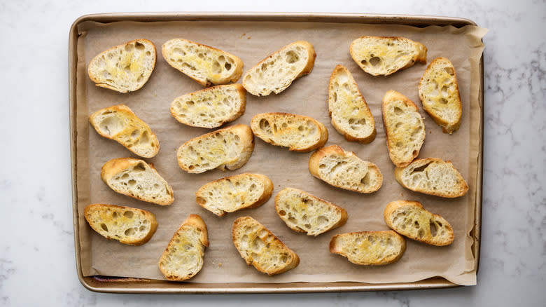 baked baguette slices on baking sheet