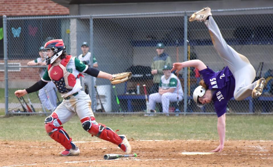 West Canada Valley Indian Derek Maxwell (right) reaches for home plate after leaping in an attempt to avoid a tag by Westmoreland catcher Caleb Miller Friday. Maxwell was called out on the play.