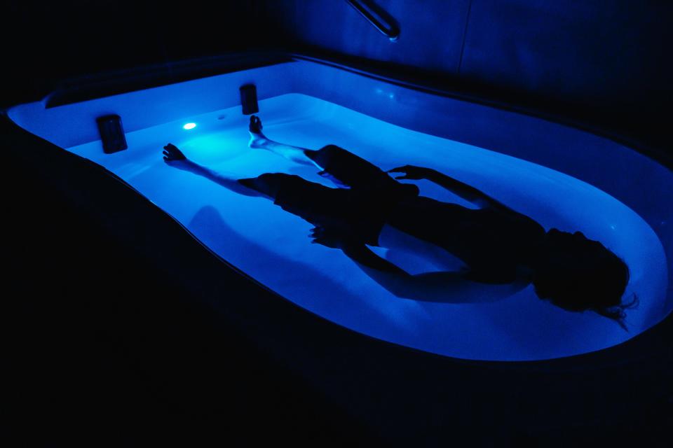 Luke Gossett demonstrates flotation in one of two private float pool suites at Solace Relaxation Massage & Float Spa in New Philadelphia.