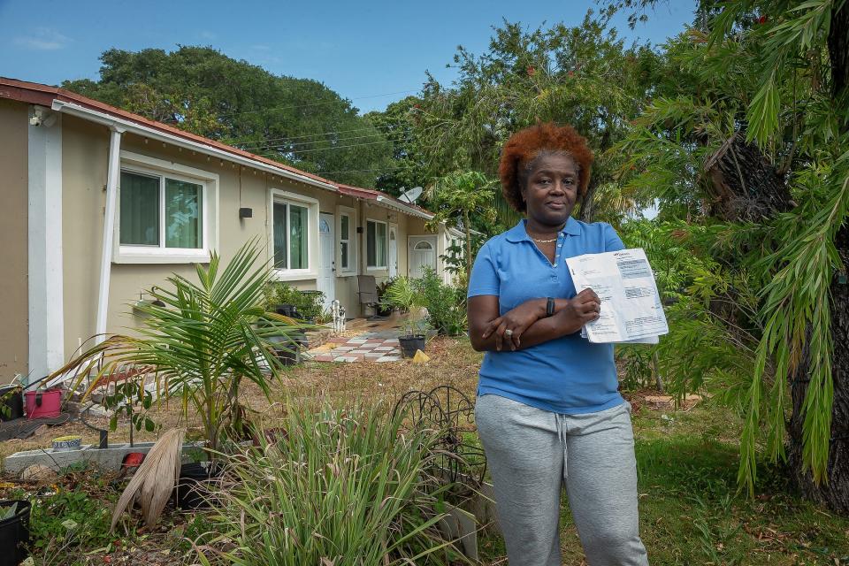 Vinnette Williams in a portrait with a $9759 Citizens Property Insurance Corporation bill that she received for her home in Boynton Beach, Fla, on April 4, 2023.