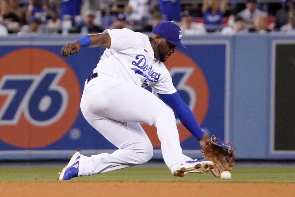 Los Angeles Dodgers second baseman Hanser Alberto can't get to a ball hit for a single by Philadelphia Phillies' Rhys Hoskins during the seventh inning of a baseball game Saturday, May 14, 2022, in Los Angeles. (AP Photo/Mark J. Terrill)