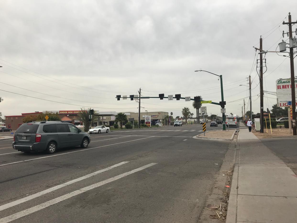 On 35th Avenue in Phoenix, a HAWK crossing signal hangs above a crosswalk.