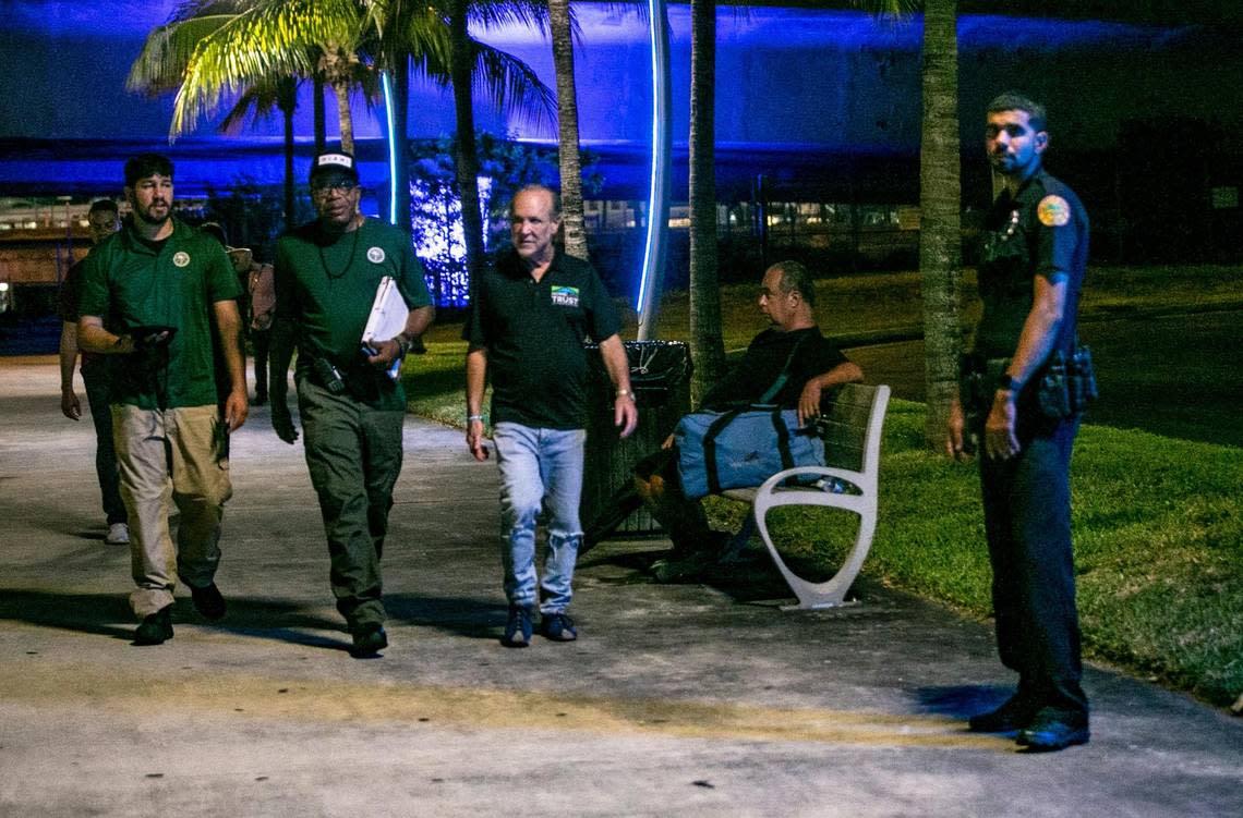 A Miami Police officer and Homeless Trust Chairman, Ronald L. Book, center, joined City of Miami Outreach Specialists, from left, Christian Candelier and Ricky Leath at Museum Park during Miami-Dade County’s annual Homeless summer census on Thursday, Aug. 18, 2022.