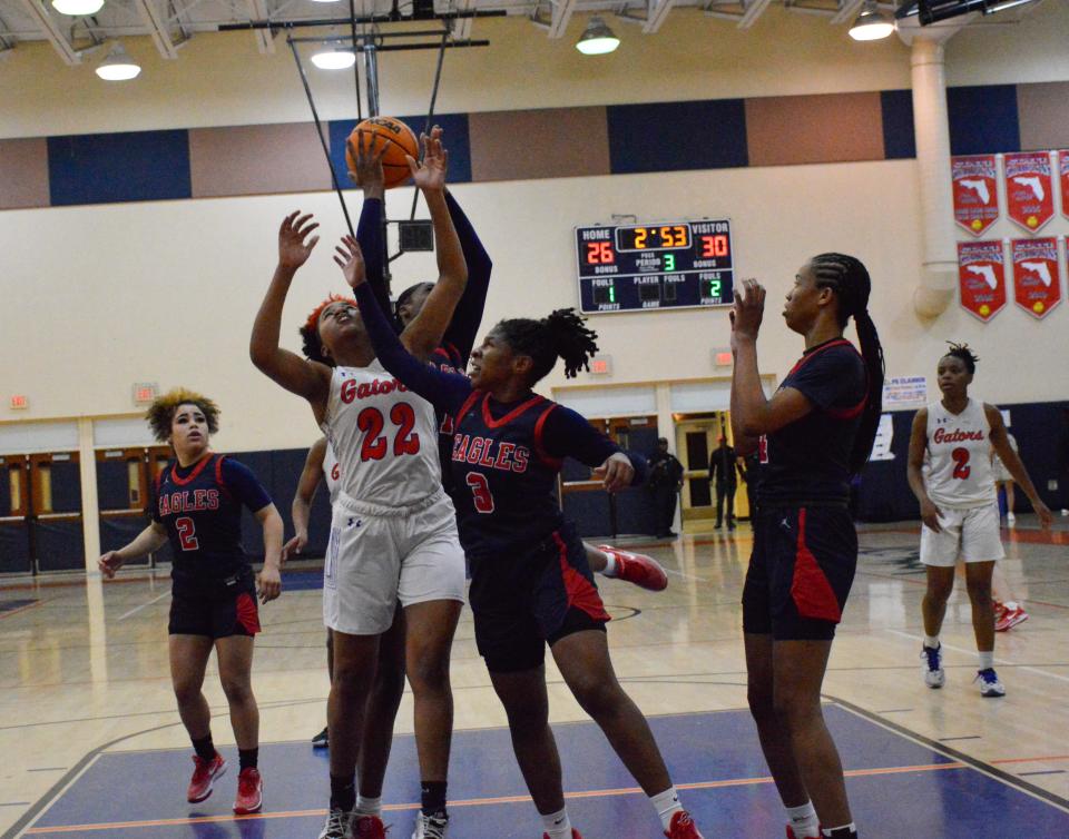 Palm Beach Gardens' Jaliyah Magwood attempt to block a shot from Centennial on Feb. 9, 2024.