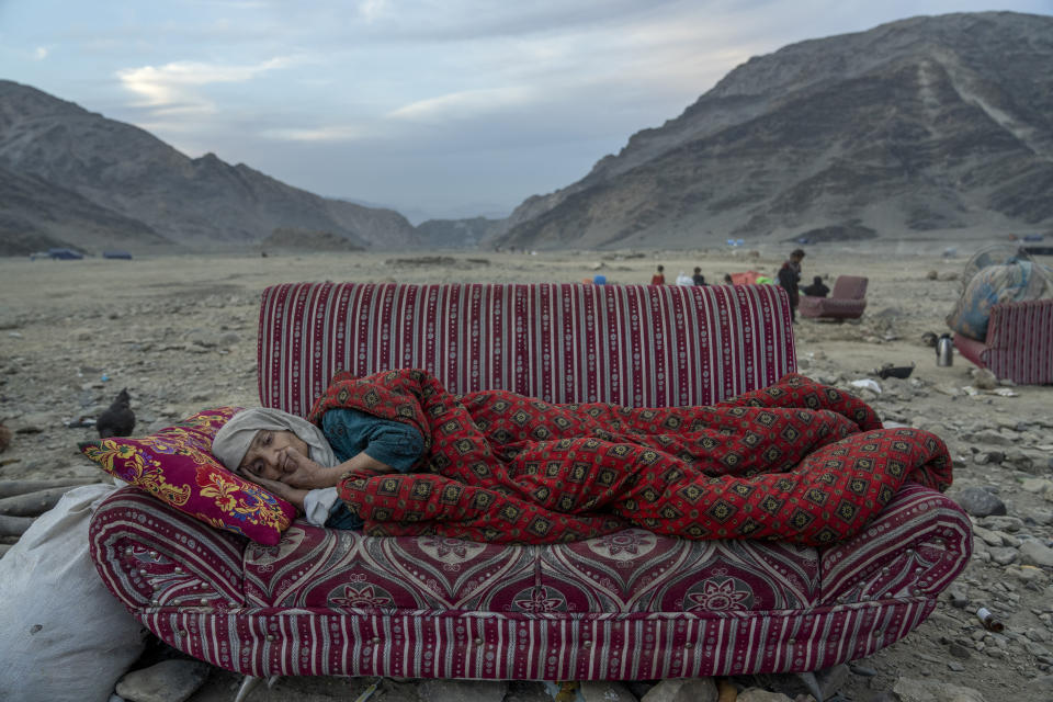 An Afghan refugee rests in the desert next to a camp near the Pakistan-Afghanistan border in Torkham, Afghanistan, Friday, Nov. 17, 2023. Many Afghan refugees arrived at the Torkham border to return home shortly before the expiration of a Pakistani government deadline for those who are in the country illegally, or face deportation. (AP Photo/Ebrahim Noroozi)