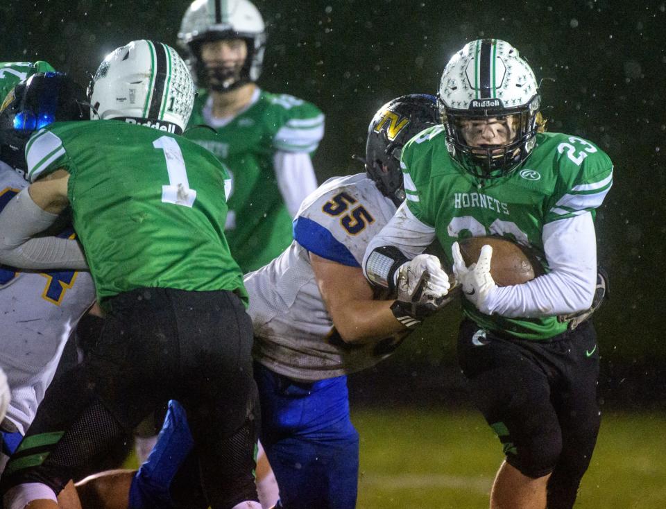 Eureka's Mason Boles (23) tries to outrun Downs Tri-Valley's Andrew Moore in the first half Friday, Oct. 15, 2021 in Eureka. The Hornets fell to the Vikings 29-7.