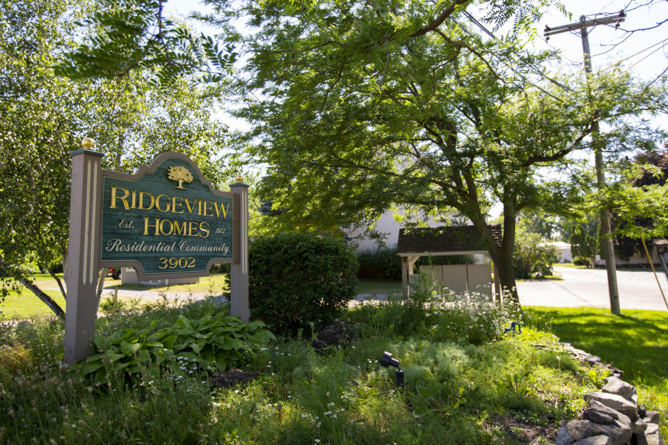 One of the entrances to the Ridgeview Homes mobile home community in Lockport, N.Y. is shown June 23, 2022. For as long as anyone can remember, rent increases rarely happened at Ridgeview Homes, a once family-owned mobile home park in upstate New York. That changed in 2018 when corporate owners took over the 65-year-old park located amid farmland about 30 miles northeast of Buffalo. The plight of residents at Ridgeview is playing out nationwide as institutional investors, led by private equity firms and real estate trusts and sometimes funded by pension funds, swoop in to buy mobile home parks. (AP Photo/Lauren Petracca)